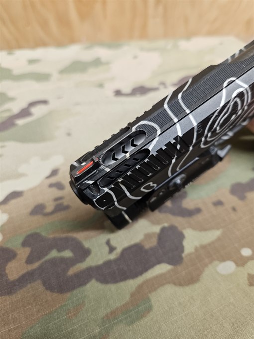 Ported and windowed slide finished in black with a custom white line pattern